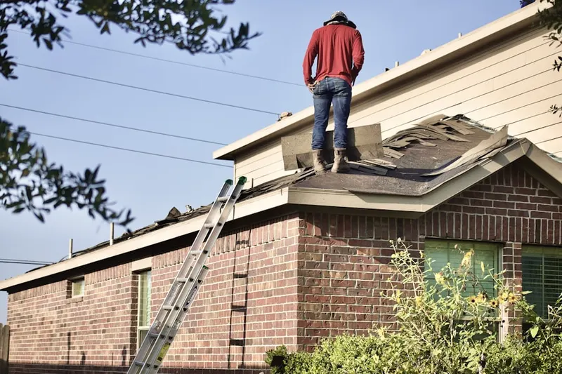 Professional roofer working on a residential roof in Westwood South